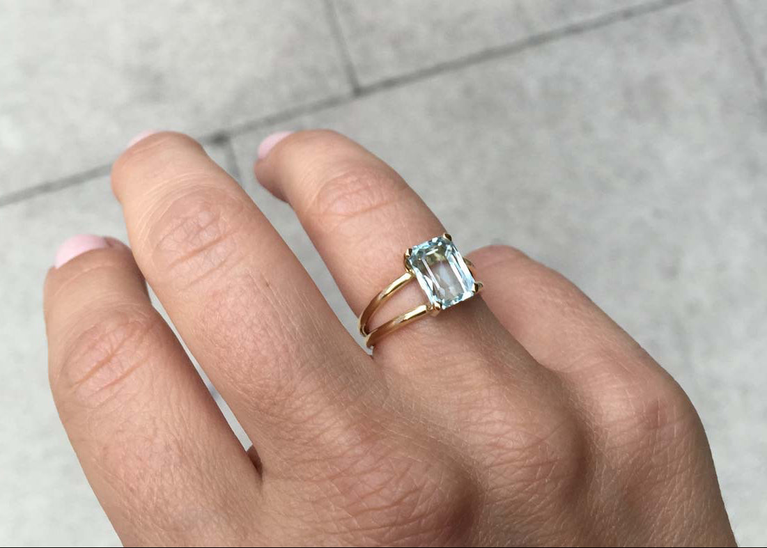 Bridal Emerald-Cut Aquamarine Ring by Bianca Jones Jewellery, London: Joyful aquamarine set on two handcrafted yellow gold bands.