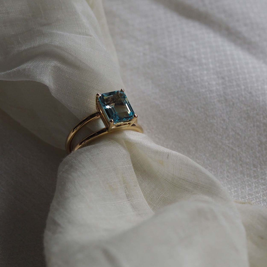 Bridal Emerald-Cut Aquamarine Ring by Bianca Jones Jewellery, London: Joyful aquamarine set on two handcrafted yellow gold bands.