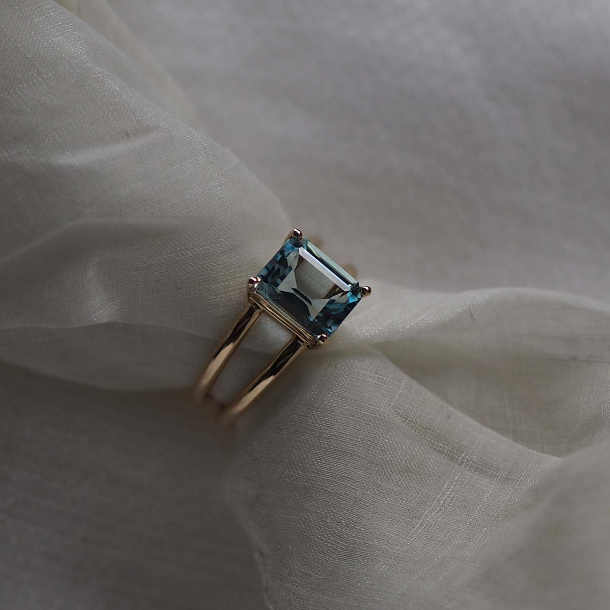 Bridal Emerald-Cut Aquamarine Ring by Bianca Jones Jewellery, London: Joyful aquamarine set on two handcrafted yellow gold bands.