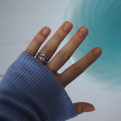 Handmade Oval Aquamarine Ring from Bianca Jones Jewellery, London. Showcases an oval aquamarine stone set atop two white gold bands