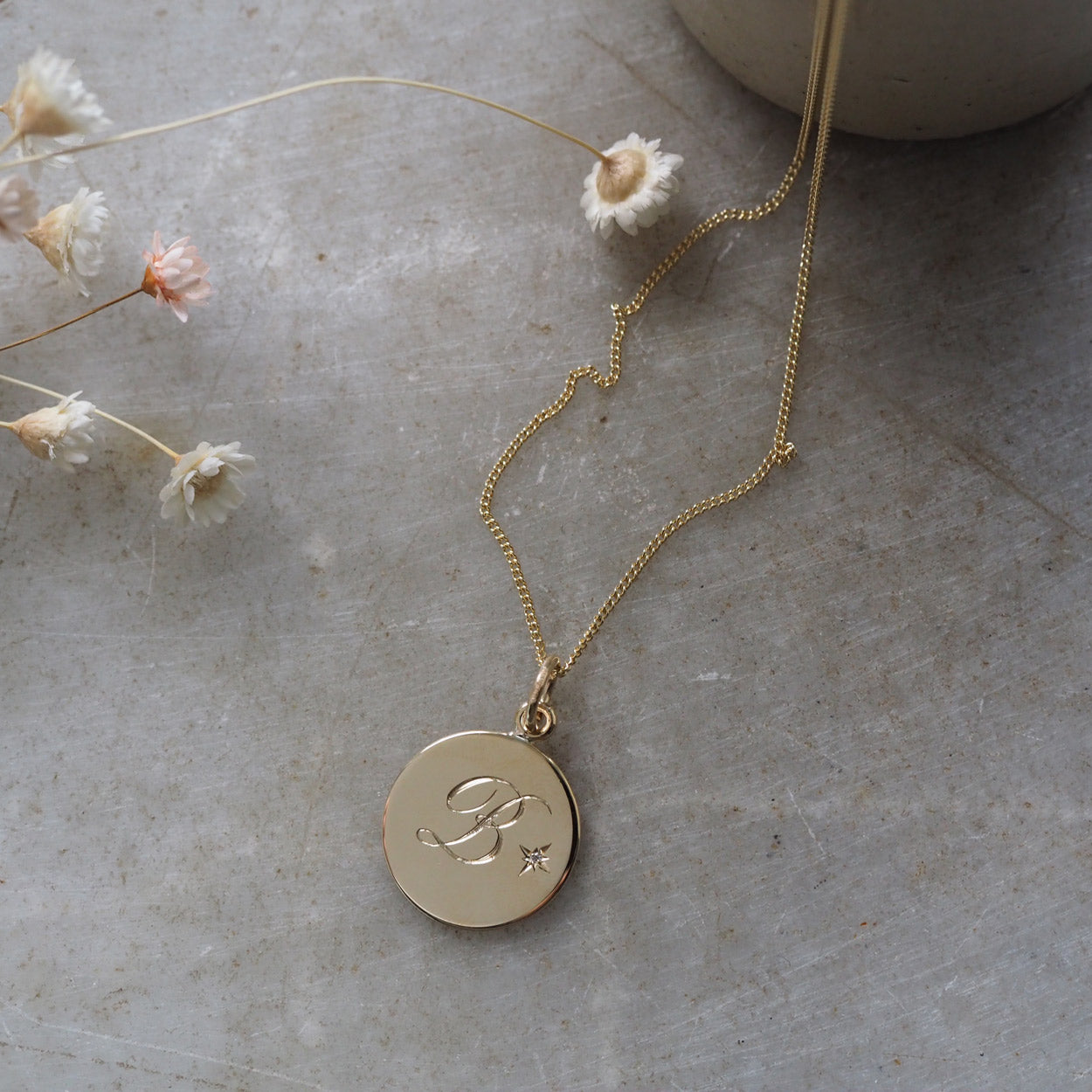 Diamond Initial Necklace in Solid 9ct Yellow Gold with a hand-engraved initial and a brilliant-cut diamond set in a Victoriana star-setting. A timeless piece celebrating love and cherished memories.