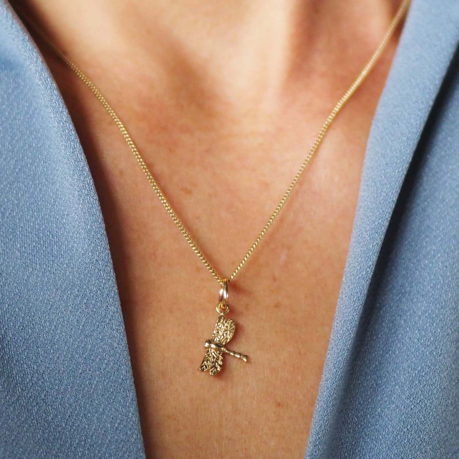 Solid gold dragonfly necklace handcrafted in London, a meaningful talisman of transformation and joy.