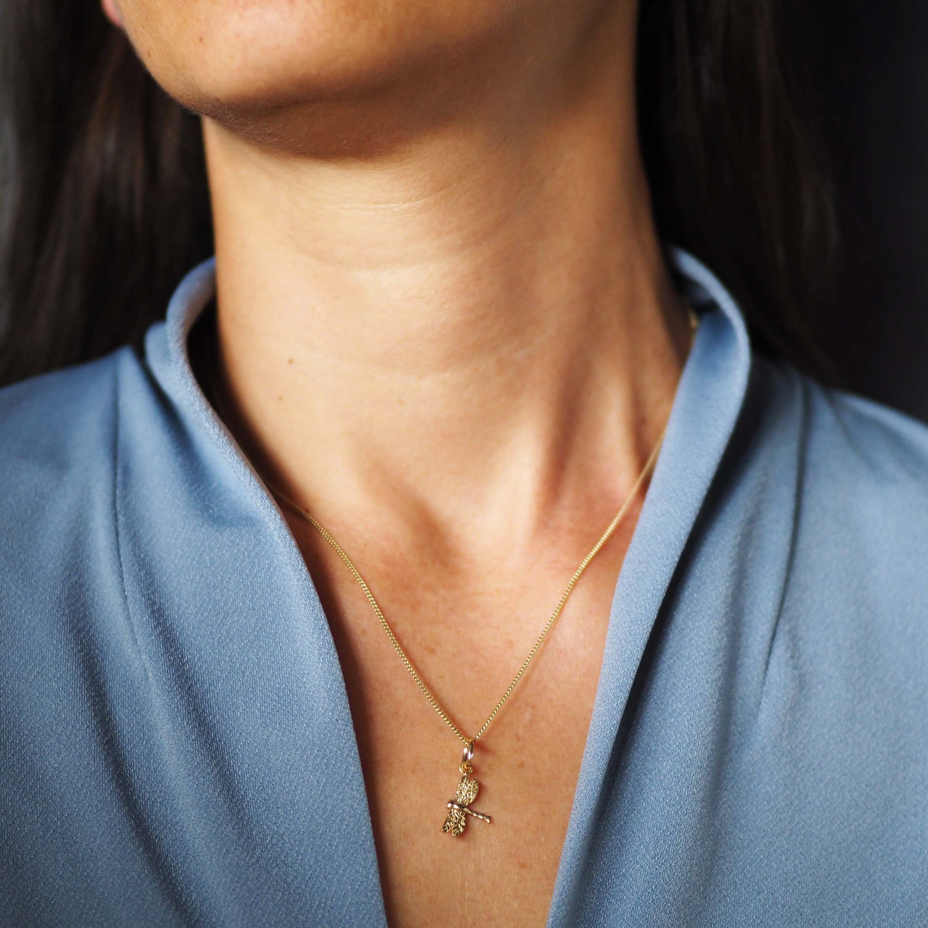 Solid gold dragonfly necklace handcrafted in London, a meaningful talisman of transformation and joy.