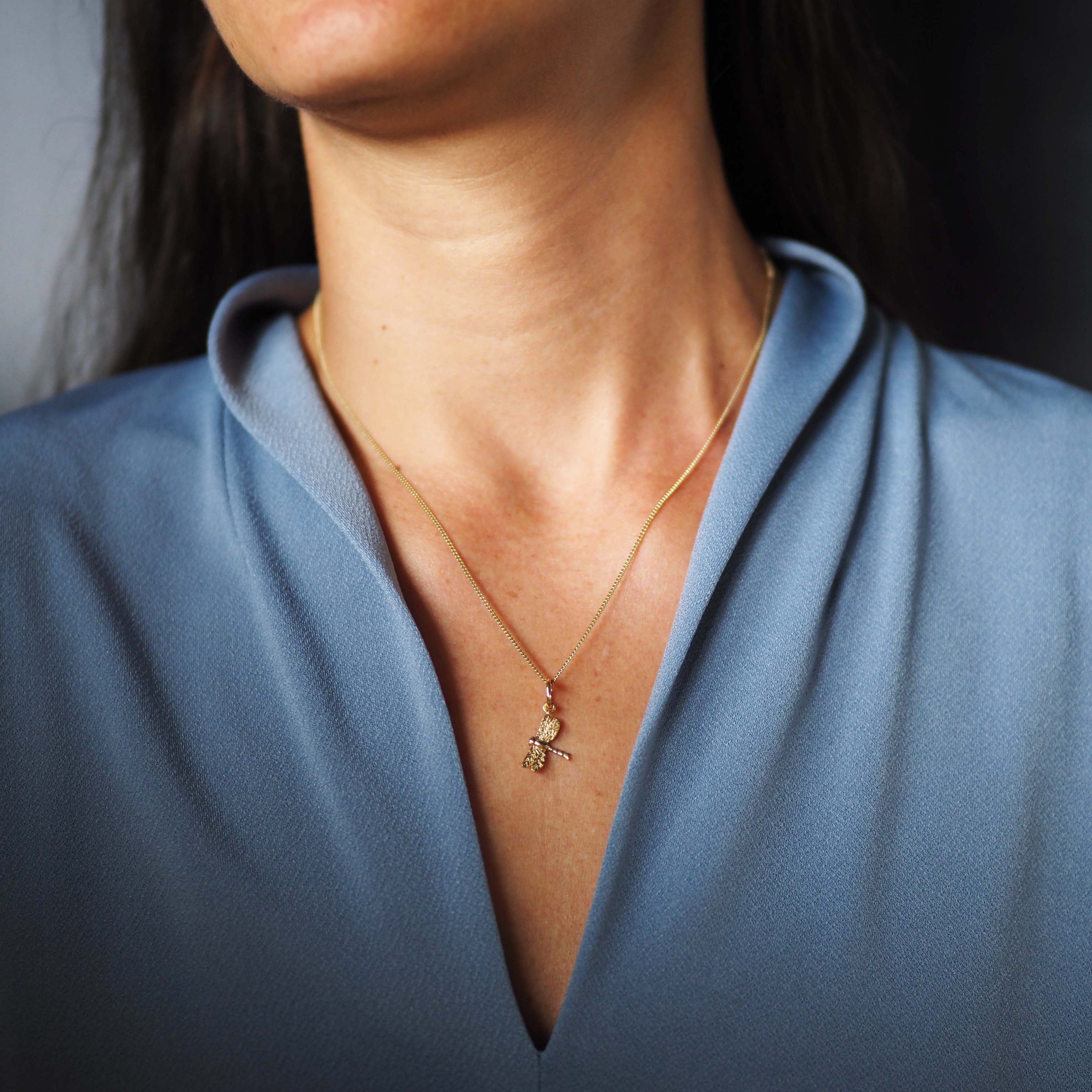 Solid gold dragonfly necklace handcrafted in London, a meaningful talisman of transformation and joy.