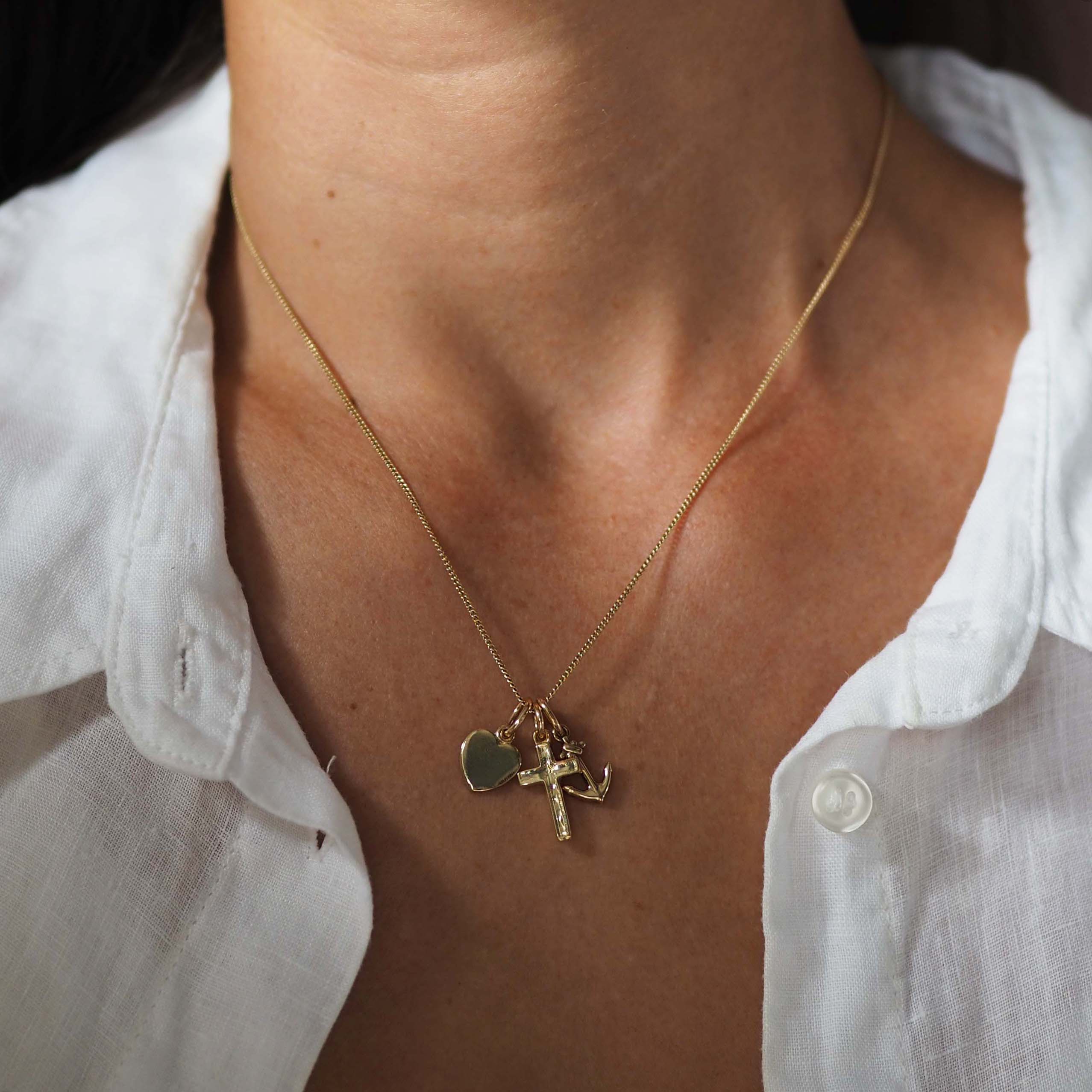 Faith, Hope & Charity Necklace in solid gold, featuring heart, anchor, and cross charms — a meaningful trio symbolising love, hope, and protection.