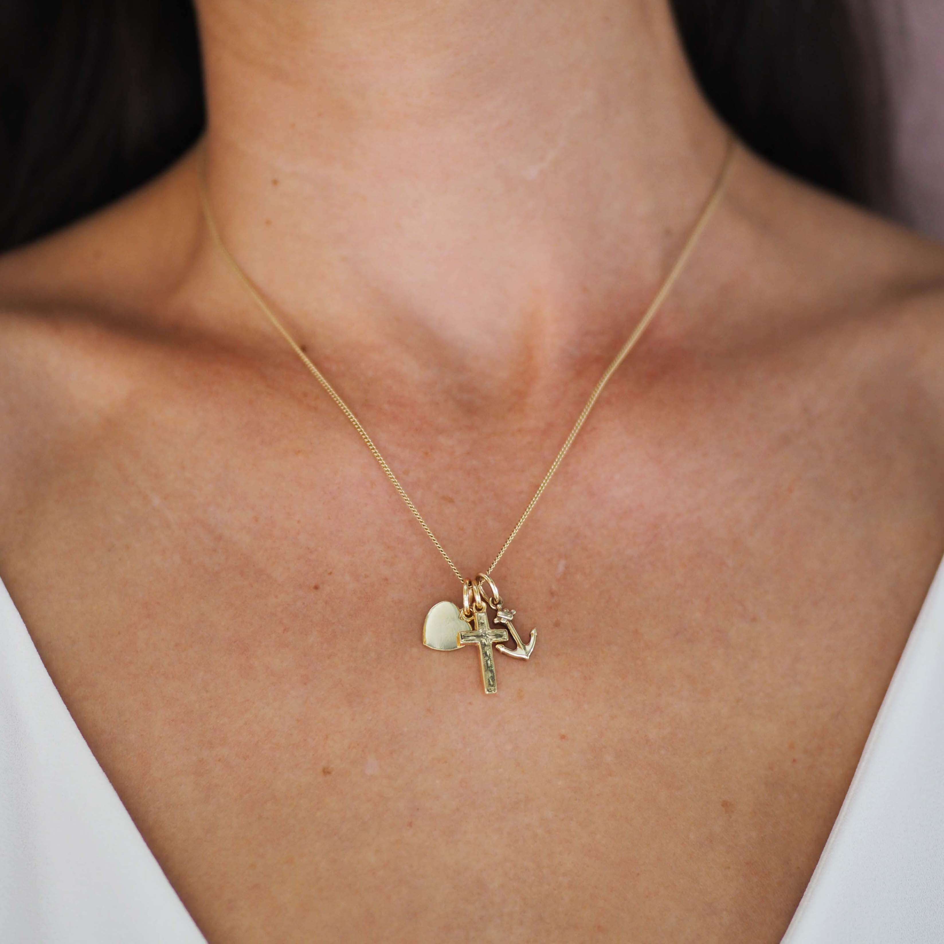 Faith, Hope & Charity Necklace in solid gold, featuring heart, anchor, and cross charms — a meaningful trio symbolising love, hope, and protection.