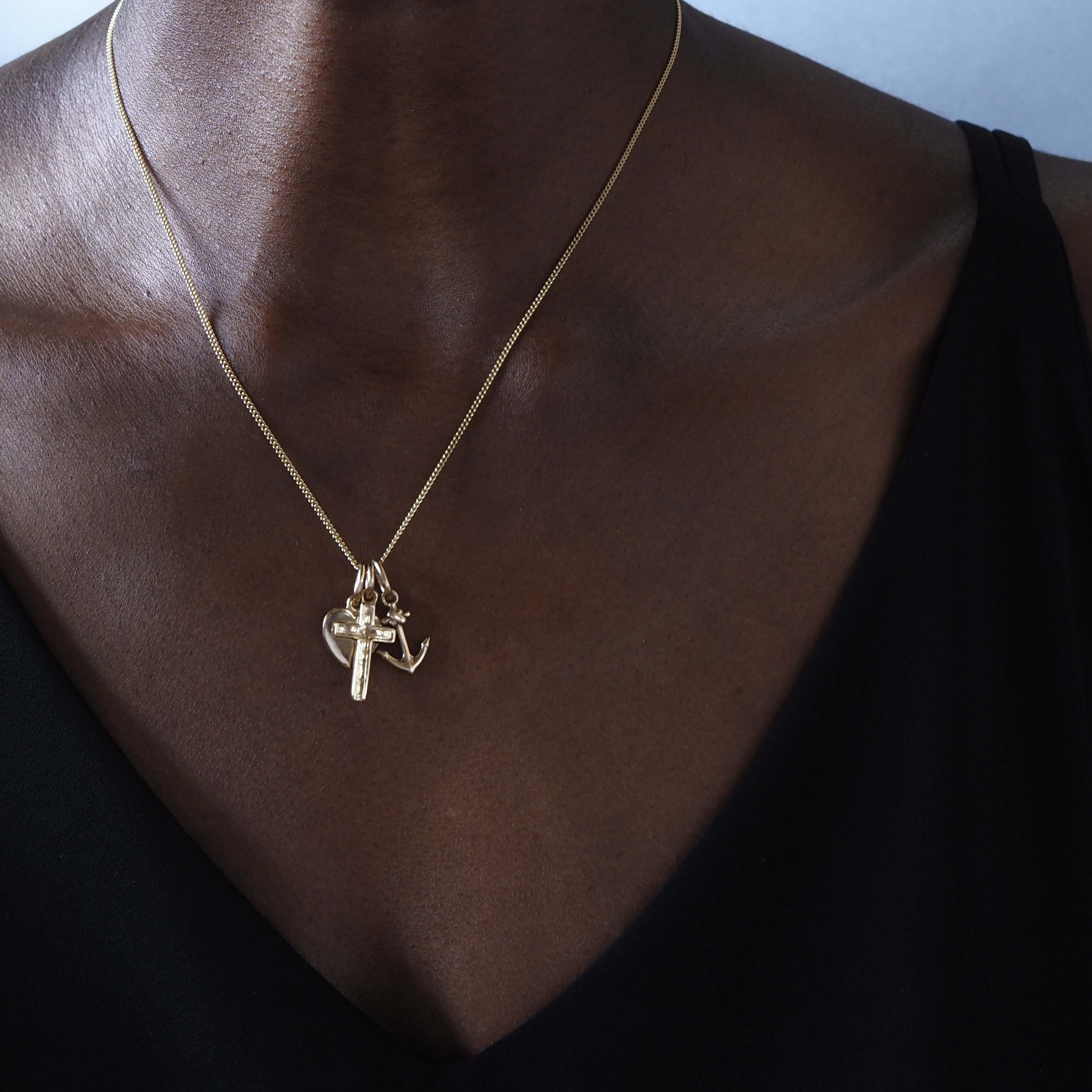 Faith, Hope, and Charity Necklace in solid 9ct gold, showcasing a heart, anchor, and cross charm. Available in Yellow, White, or Rose Gold, symbolising love, hope, and protection.