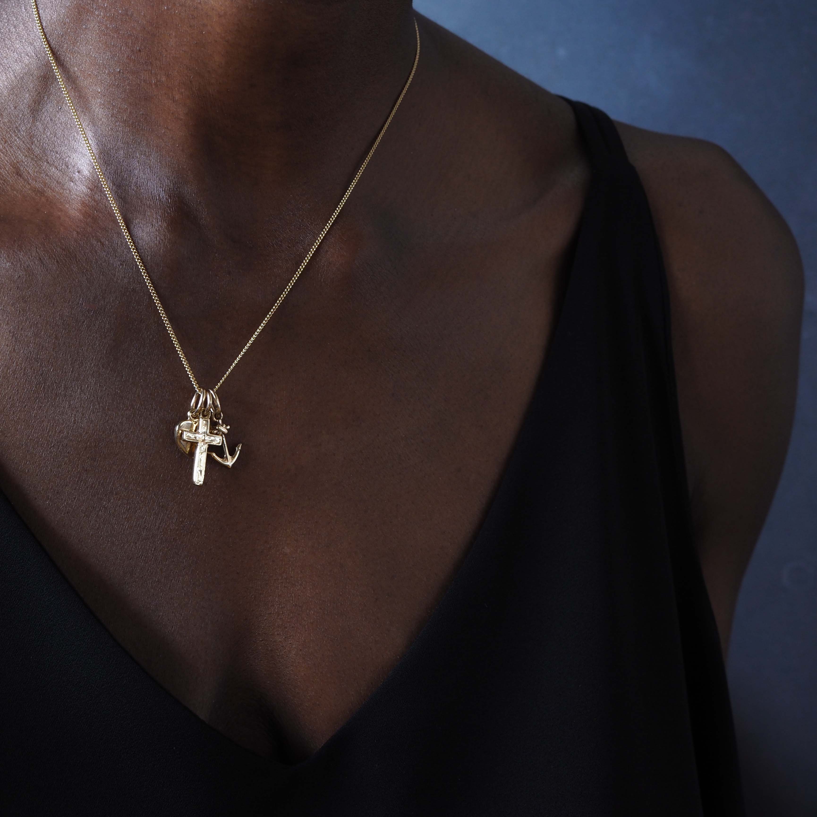 Faith, Hope & Charity Necklace in solid gold, featuring heart, anchor, and cross charms — a meaningful trio symbolising love, hope, and protection.