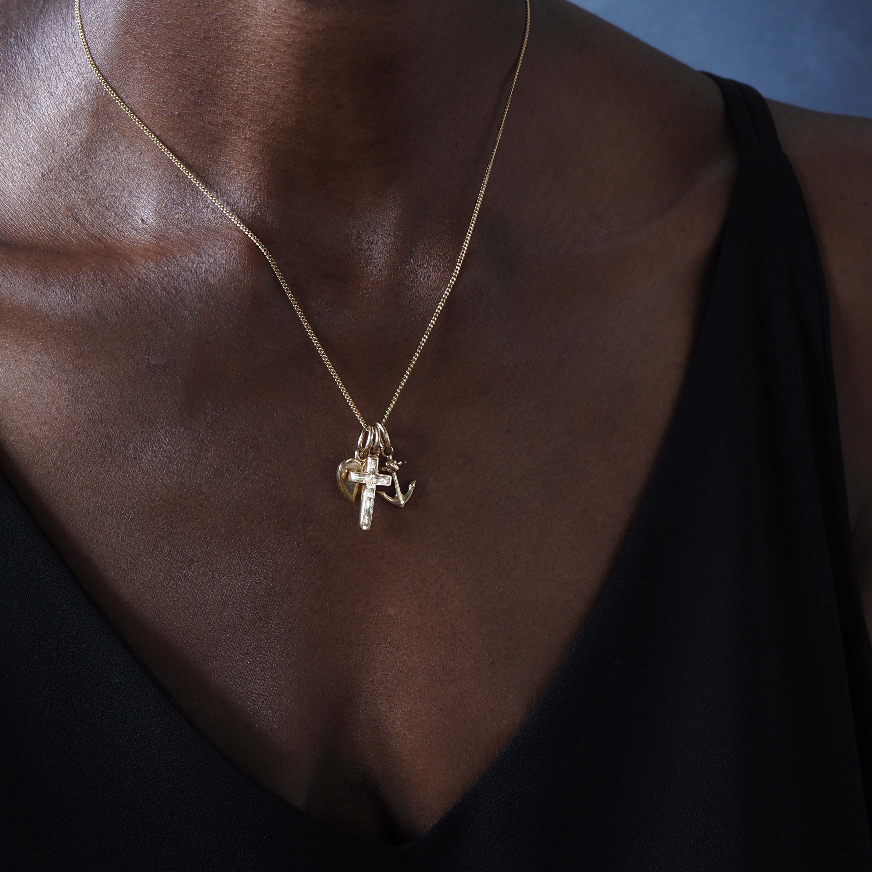 Faith, Hope & Charity Necklace in solid gold, featuring heart, anchor, and cross charms — a meaningful trio symbolising love, hope, and protection.