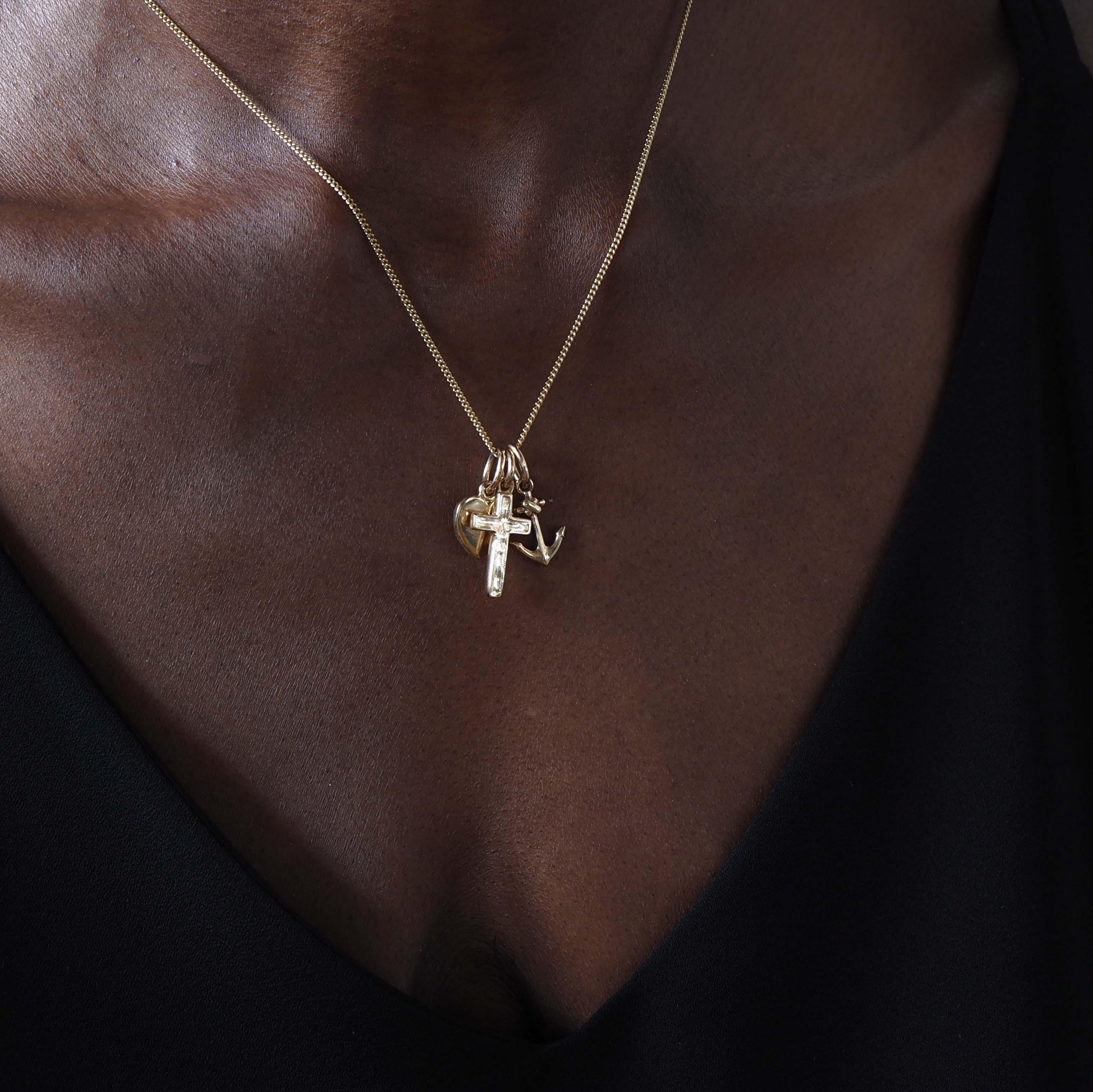 Faith, Hope & Charity Necklace in solid gold, featuring heart, anchor, and cross charms — a meaningful trio symbolising love, hope, and protection.