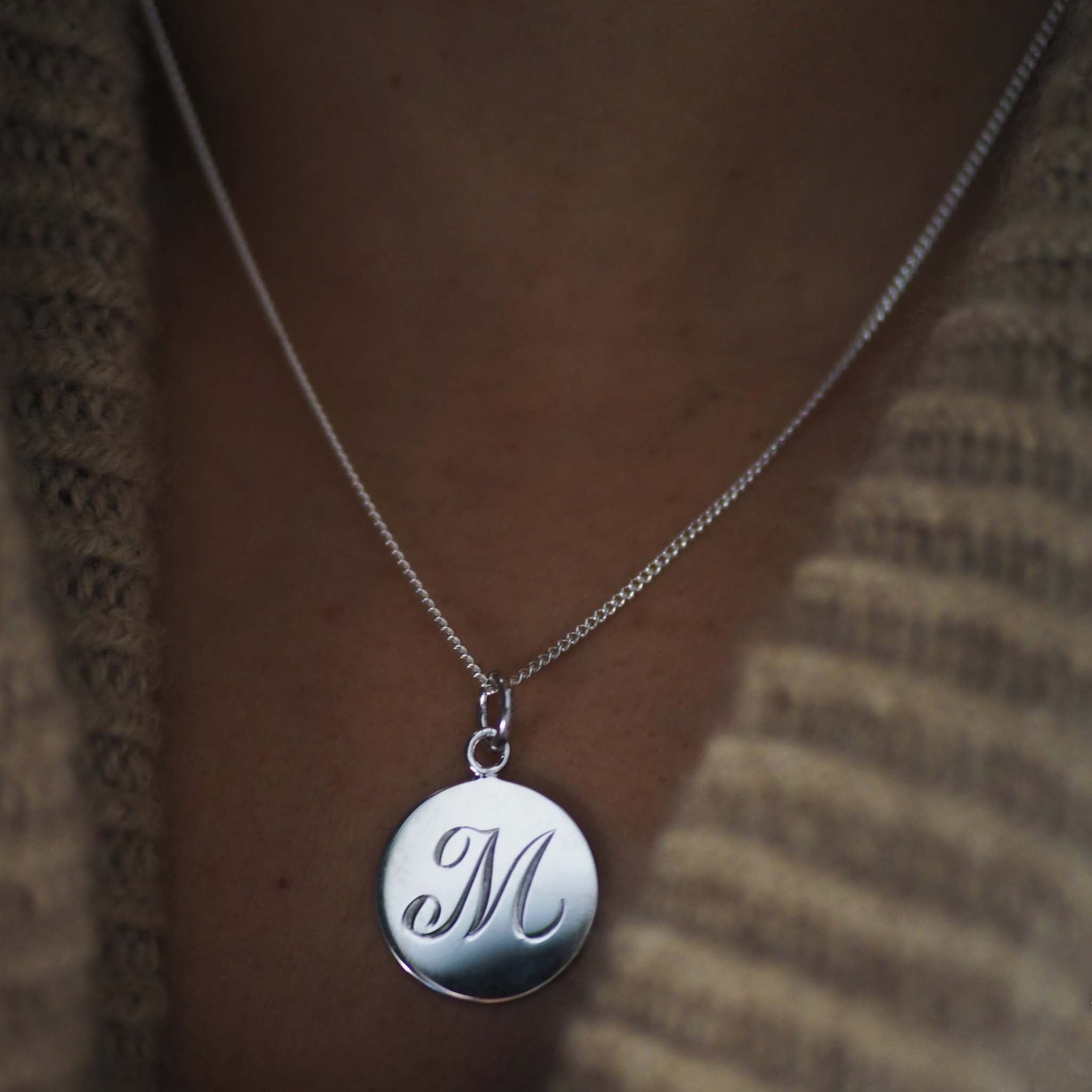 Bianca Jones hand-engraved script initial charm available in silver or gold vermeil, offering a personalised touch of elegance