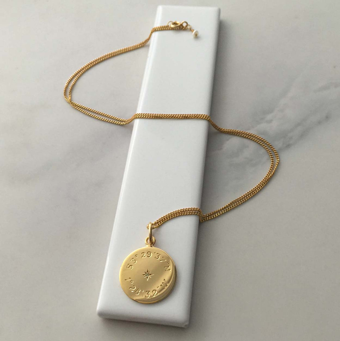 Latitude and Longitude Diamond Necklace in gold vermeil, featuring personalised coordinates, evoking celestial navigation and cherished memories