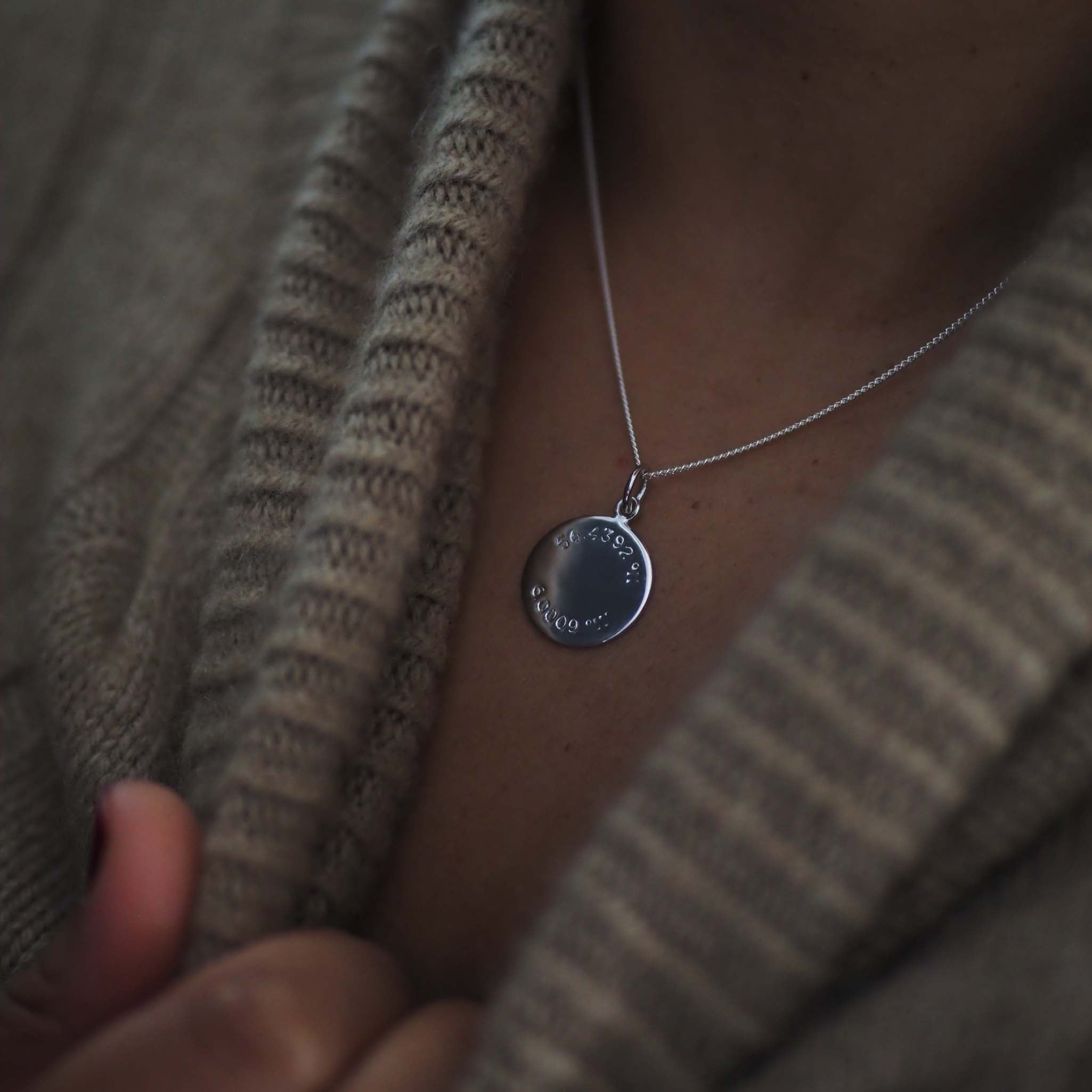 Latitude and Longitude Necklace in Sterling Silver, featuring hand-engraved coordinates. A personalised keepsake inspired by ancient celestial navigation.