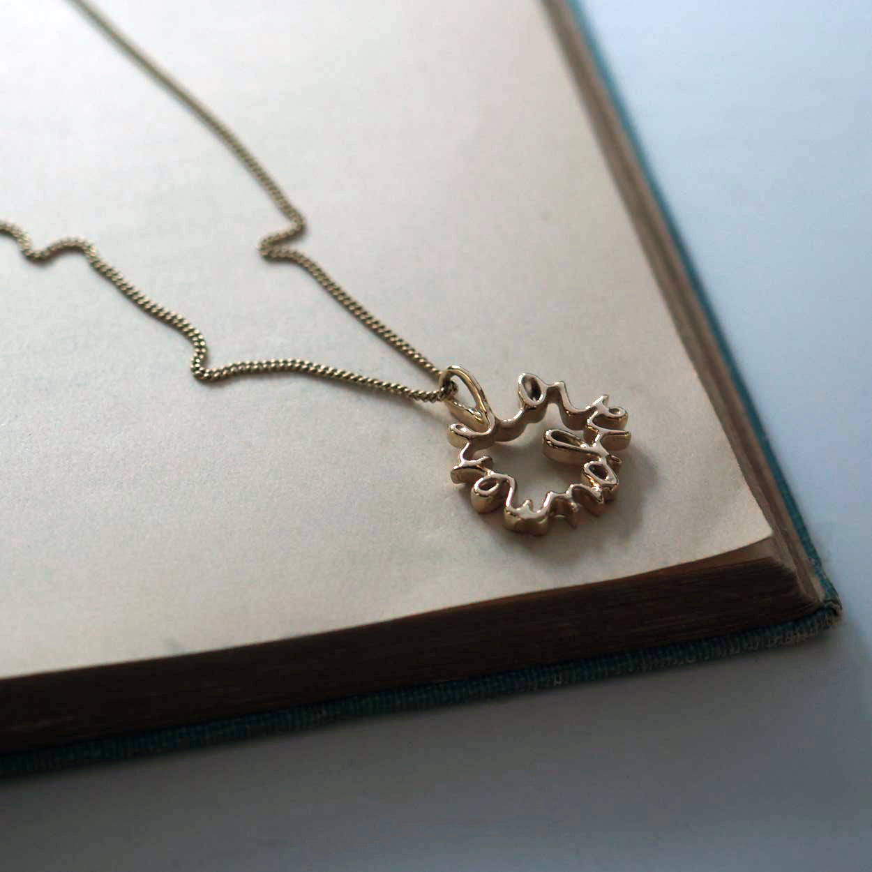 Love You More Petite Necklace in solid yellow, white, or rose gold — delicate gold pendant symbolising deep love and connection, handcrafted in London.