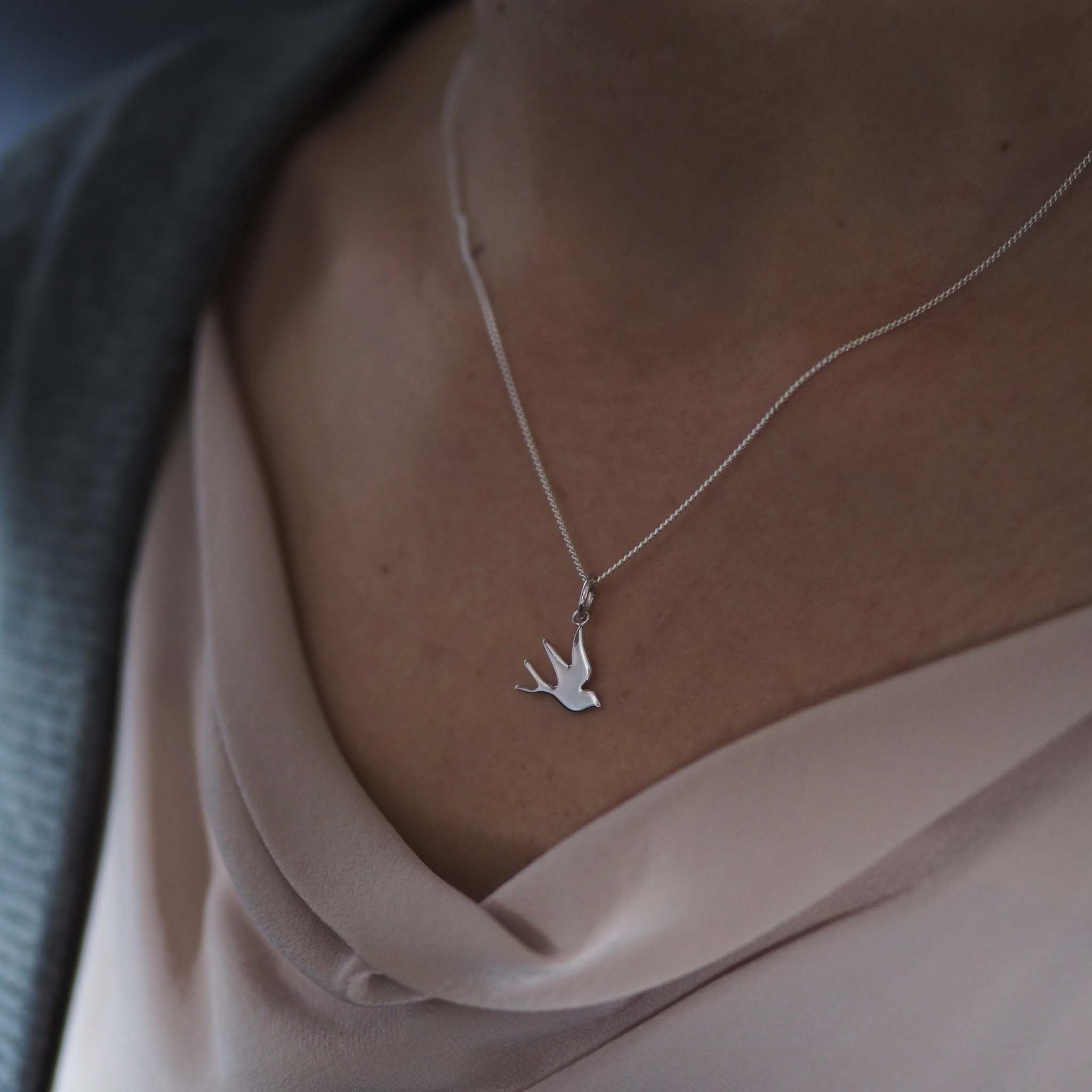 Bianca Jones flat, highly polished swallow charm in sterling silver or gold vermeil, symbolising freedom and hope