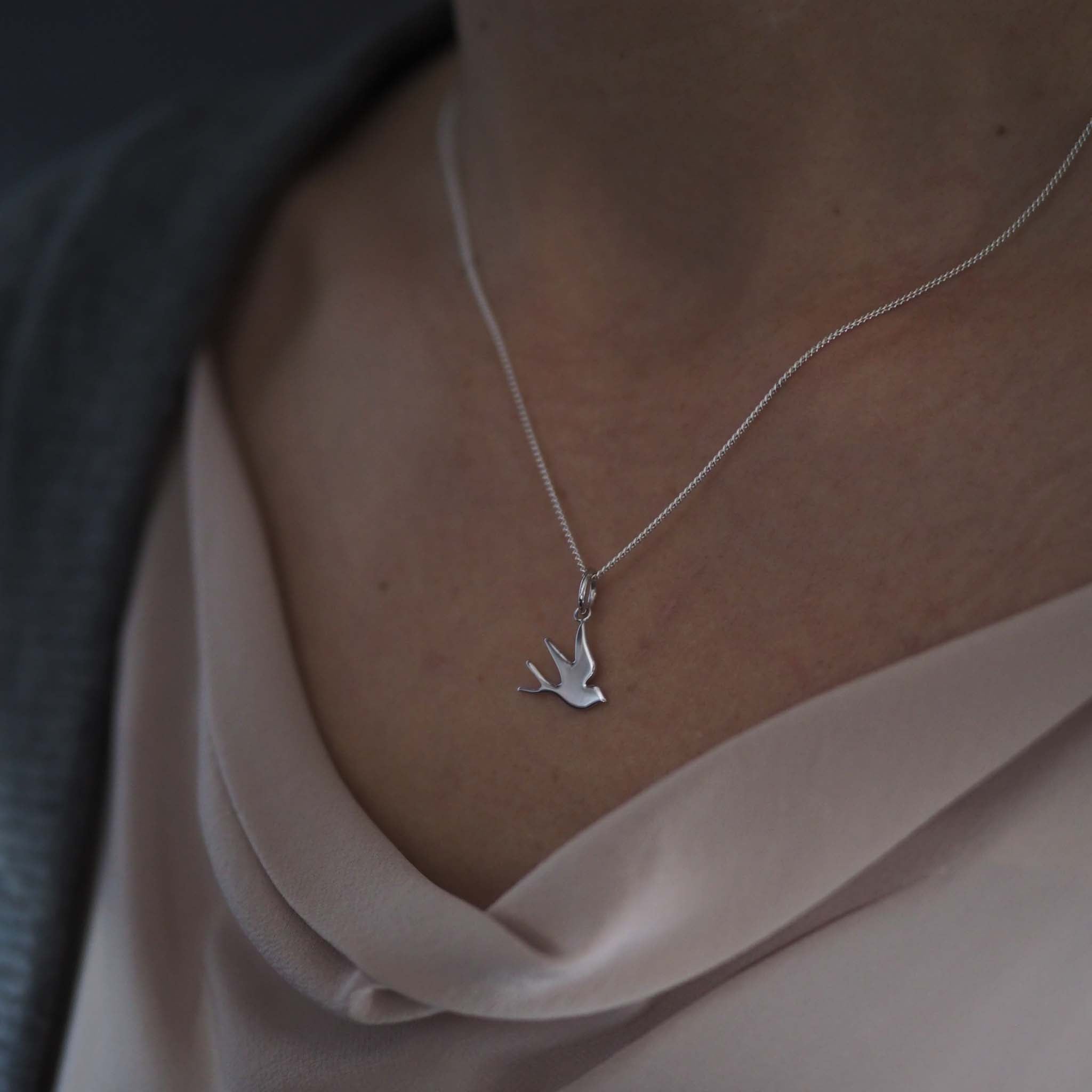 Silver swallow necklace with a delicate bird charm in recycled sterling silver or 18ct gold vermeil, handmade in London by Bianca Jones.