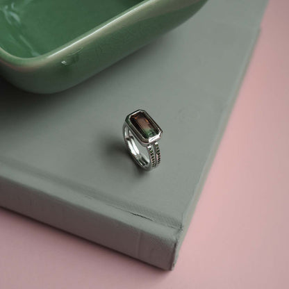 Bianca Jones Watermelon Tourmaline Engagement Ring in Recycled White Gold with Green Tourmaline Accents and Rub-Over Setting