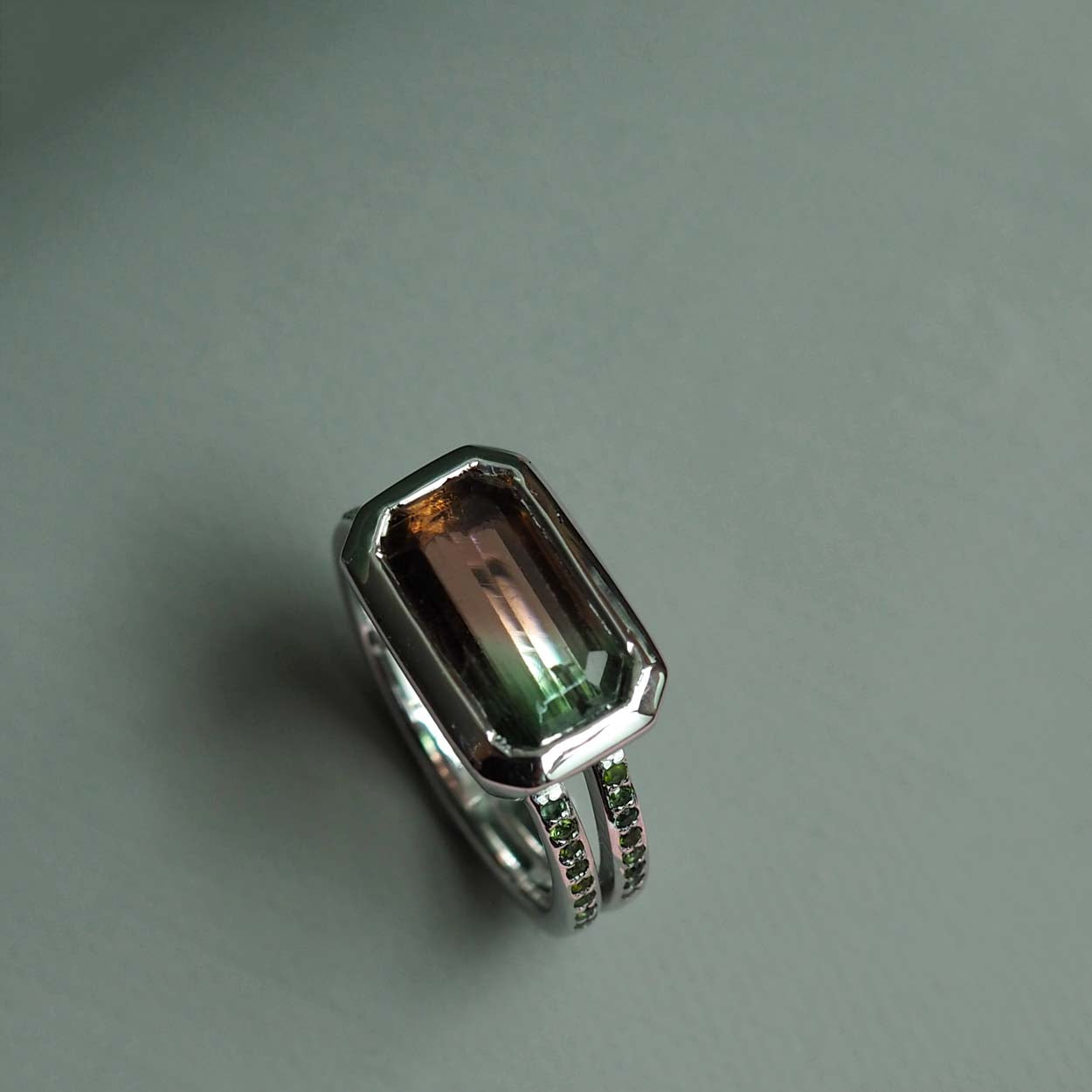 Bianca Jones Watermelon Tourmaline Engagement Ring in Recycled White Gold with Green Tourmaline Accents and Rub-Over Setting