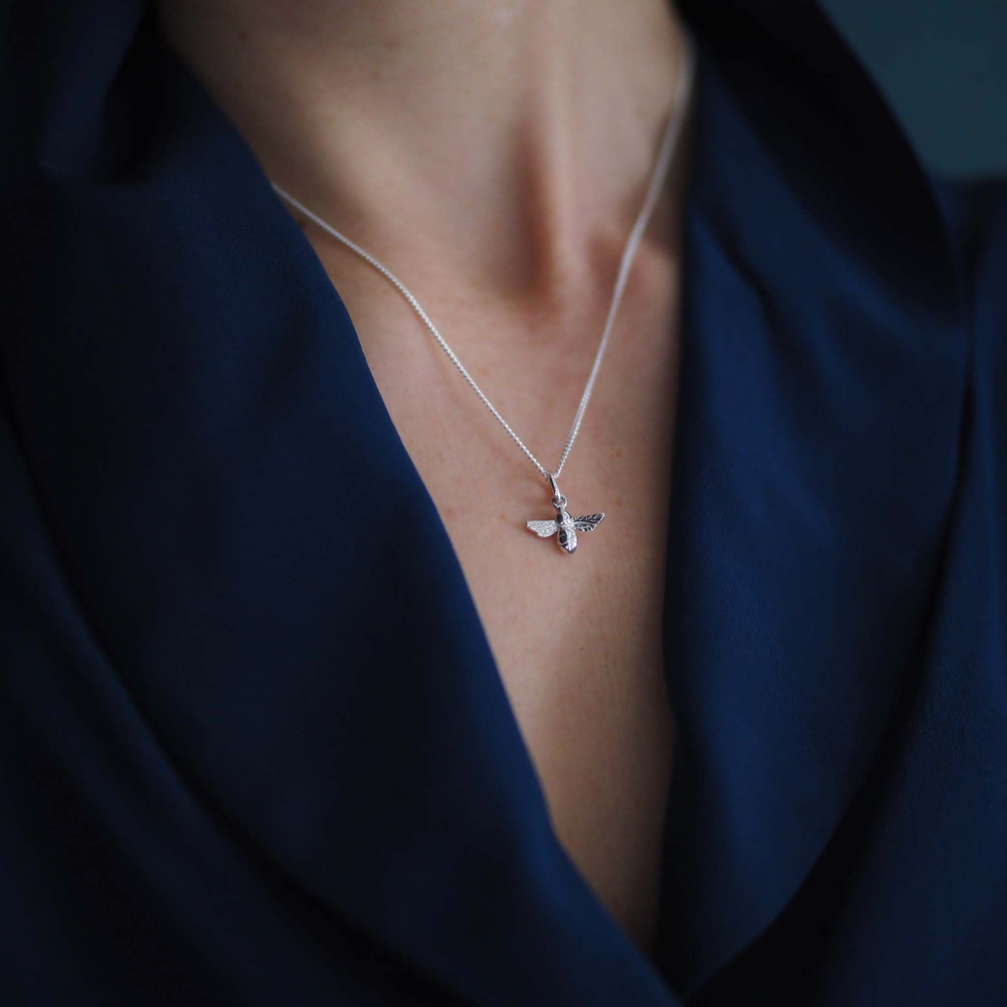 Model wearing 18ct white gold bee necklace on 18-inch chain