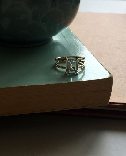 Bridal Emerald-Cut Aquamarine Ring by Bianca Jones Jewellery, London: Joyful aquamarine set on two handcrafted yellow gold bands.