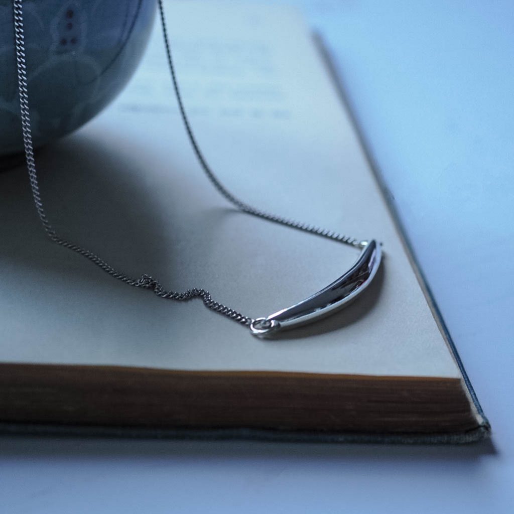 Curved sterling silver bar necklace with Forever Strong engraving, handmade jewellery inspired by strength.