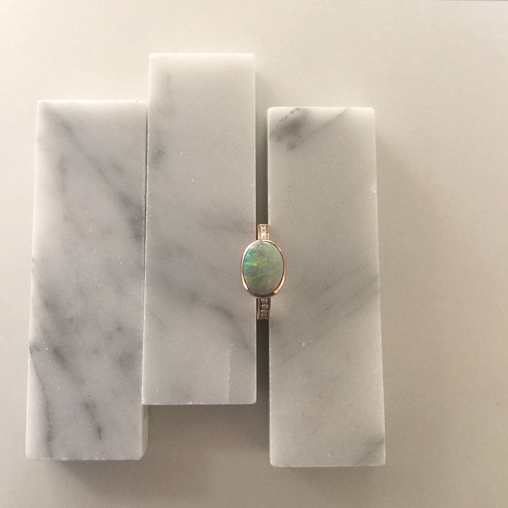 Bianca Jones bespoke opal rose gold ring with diamonds, radiating a blend of timeless romance and luxury