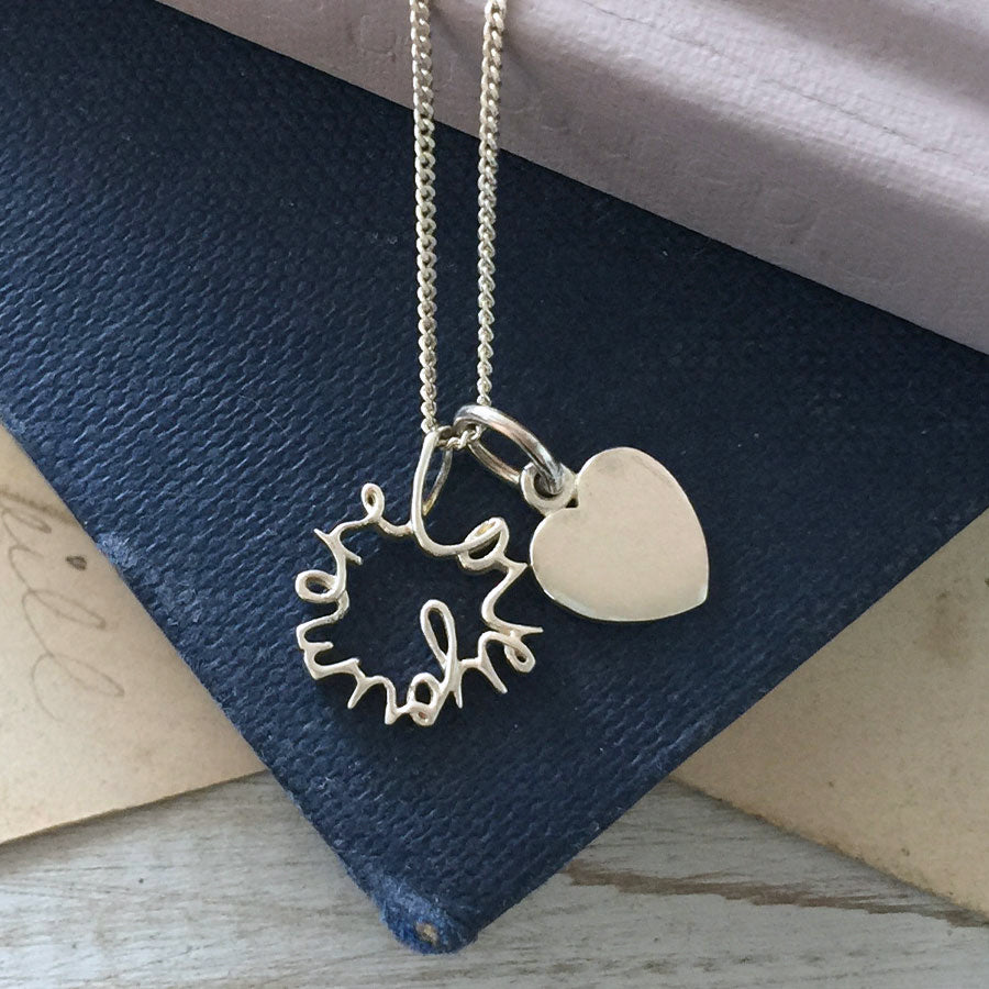 Solid gold Love You More Heart Necklace with double charm design, handcrafted in London — symbolic jewellery gift for someone special.
