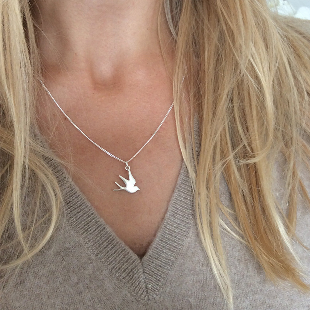 Silver swallow necklace with a delicate bird charm in recycled sterling silver or 18ct gold vermeil, handmade in London by Bianca Jones.