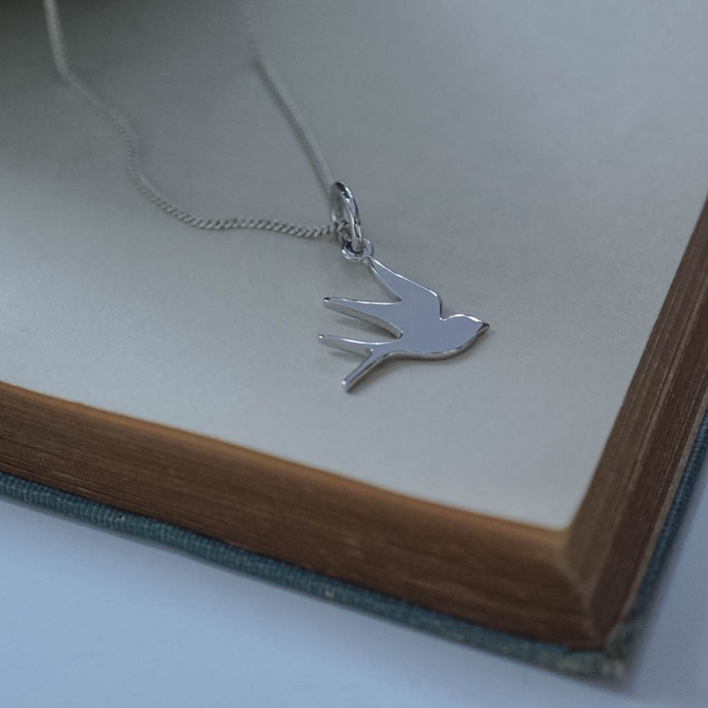 Silver swallow necklace with a delicate bird charm in recycled sterling silver or 18ct gold vermeil, handmade in London by Bianca Jones.