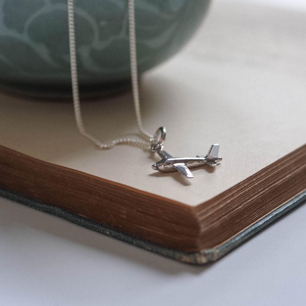 Side angle of sterling silver aeroplane pendant