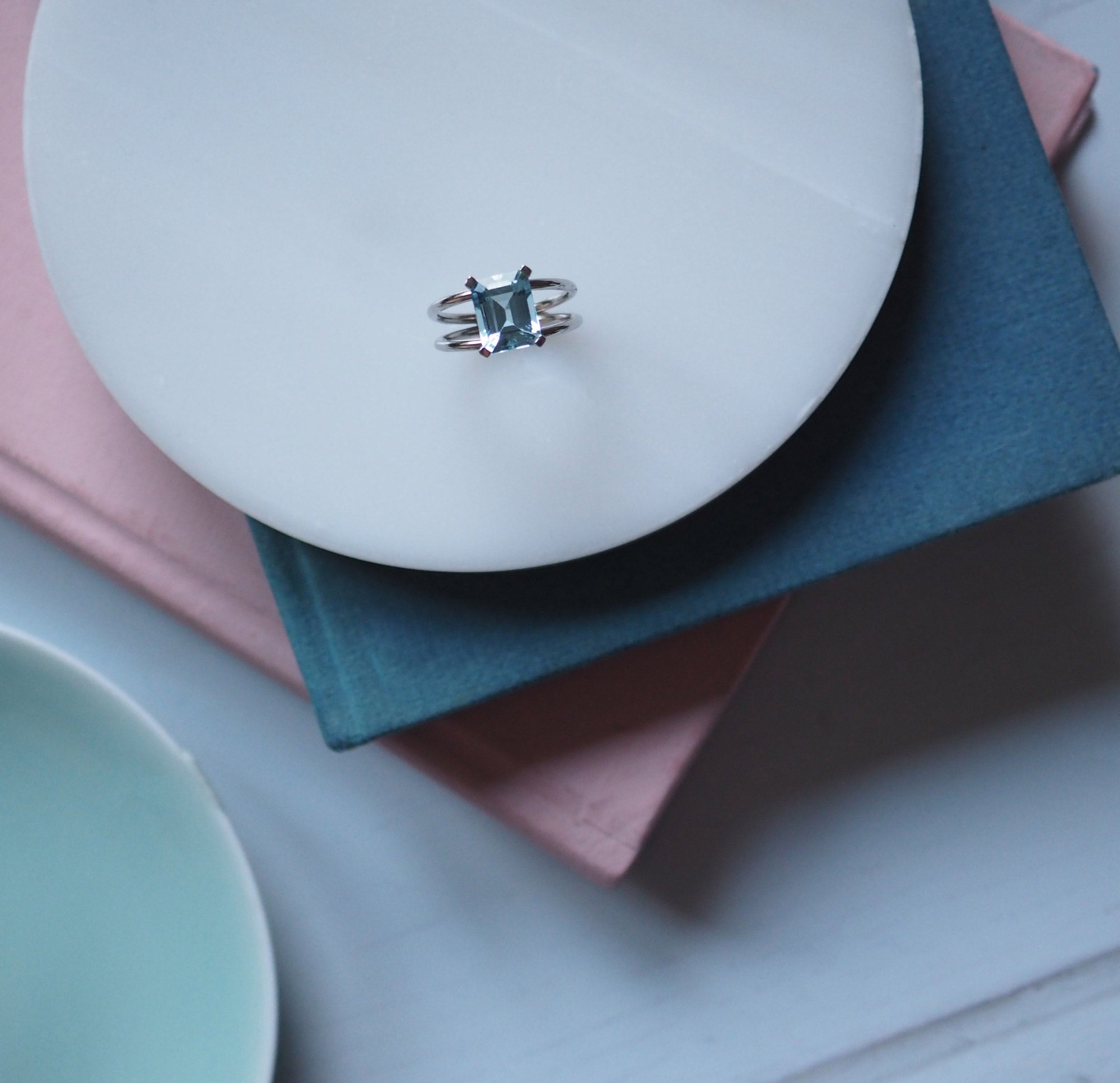 London-crafted Bridal Emerald-Cut Aquamarine Ring by Bianca Jones Jewellery, set on twin white gold bands.