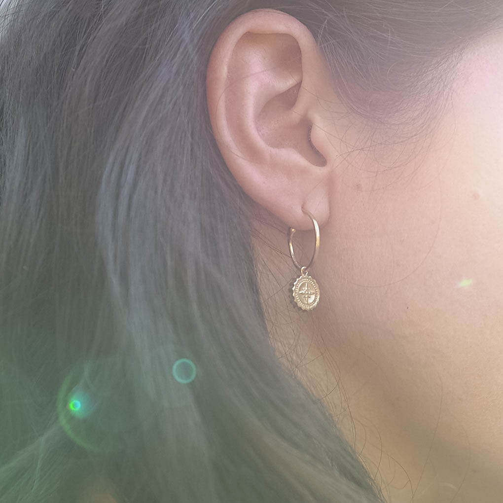 Solid gold Compass Hoop Earrings in yellow, white, or rose gold with removable engraved compass charm — handmade in London.