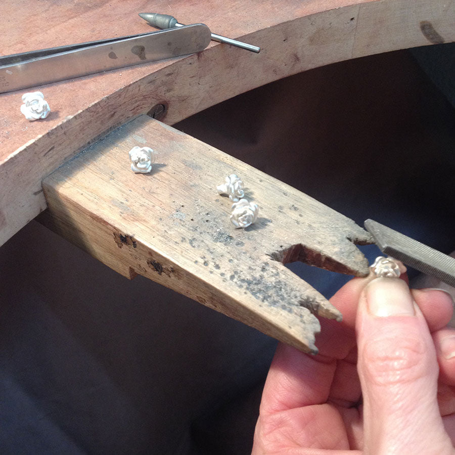 Handcrafted Rose Necklace in solid gold being made at the jeweller’s bench in London, showing traditional wax carving and goldsmithing detail