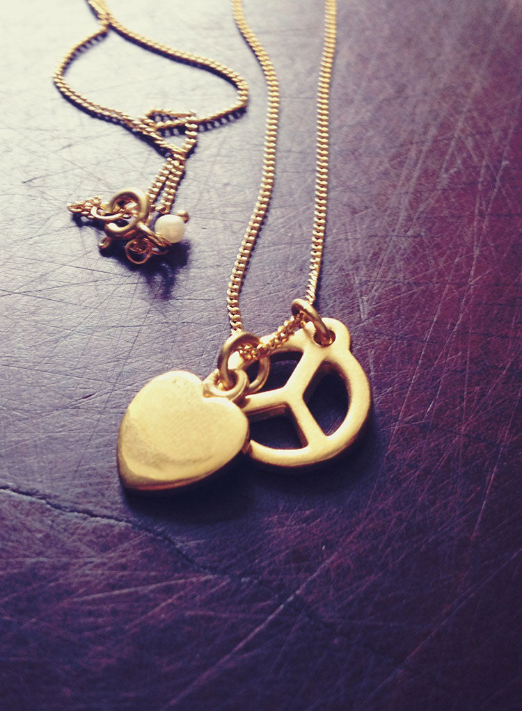 Close-up of the Peace Necklace by Bianca Jones, symbolising harmony and love with its iconic peace sign design.