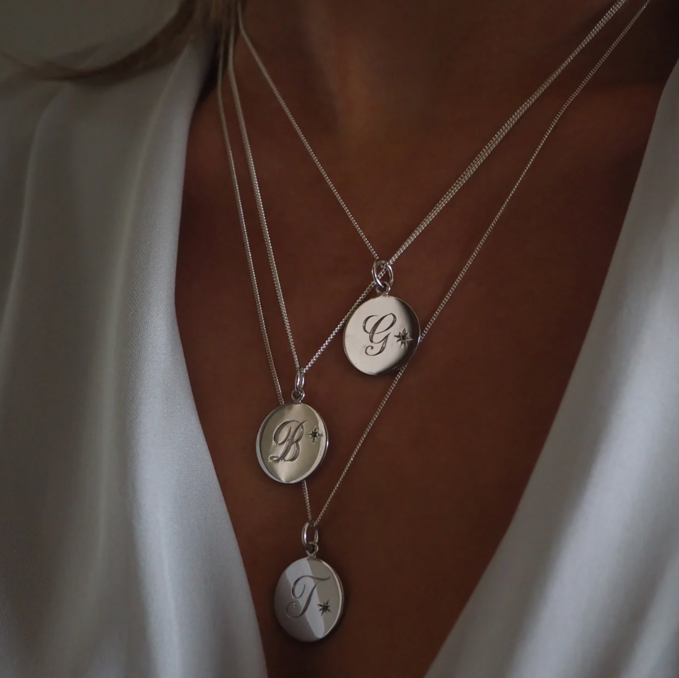 Close-up of the Initial Necklace by Bianca Jones, featuring a hand-engraved initial on a classic disc pendant.