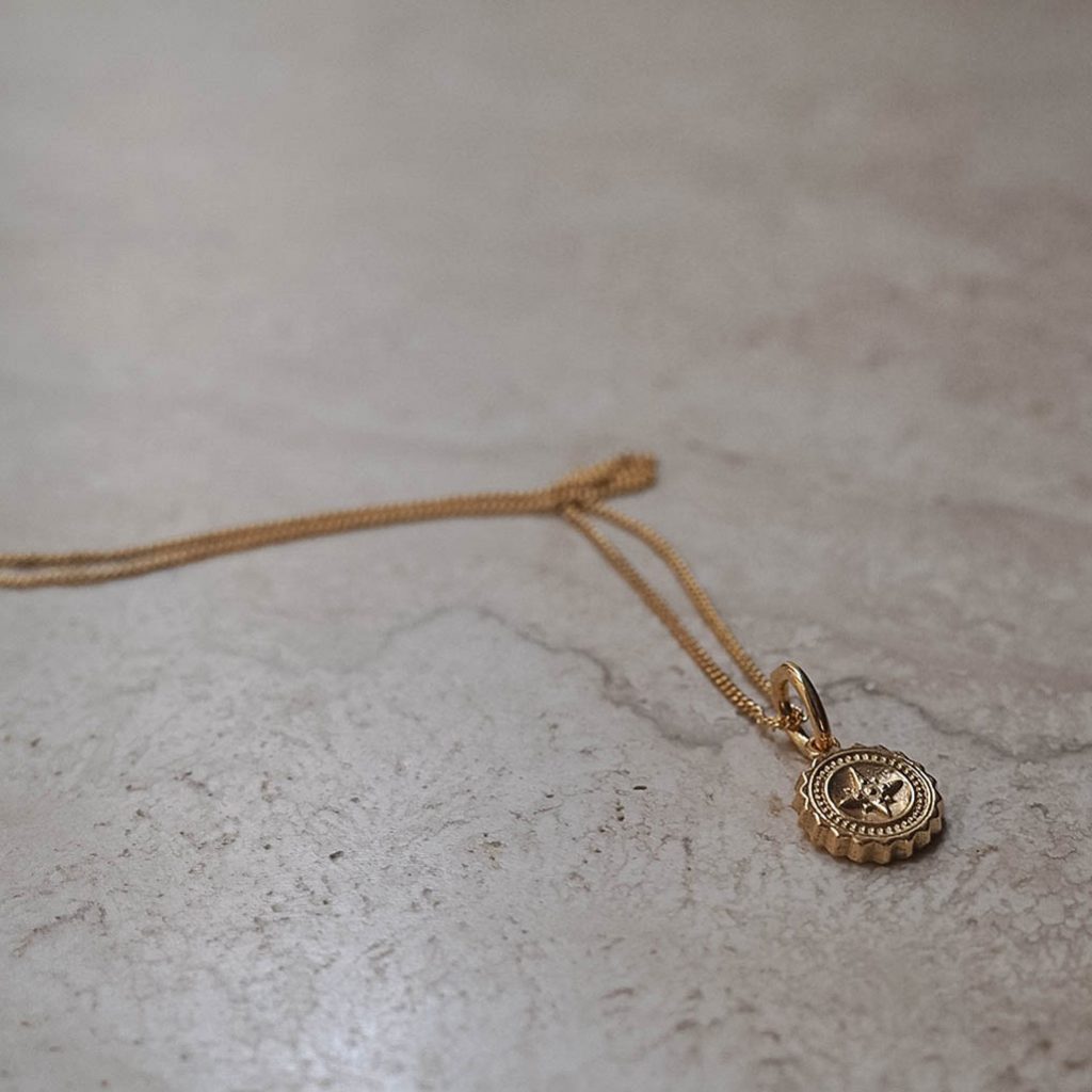 Bianca Jones compass baby necklace available in sterling silver or gold vermeil, symbolising guidance and adventure for explorers.
