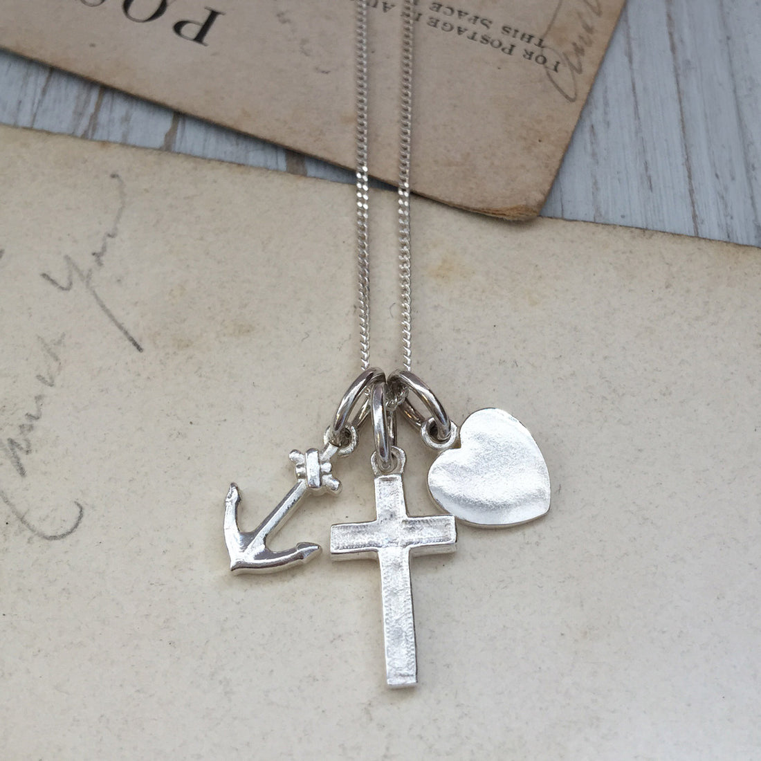 Faith, Hope, and Charity Necklace with heart, anchor, and cross symbols, intricately designed to represent love, hope, and protection.