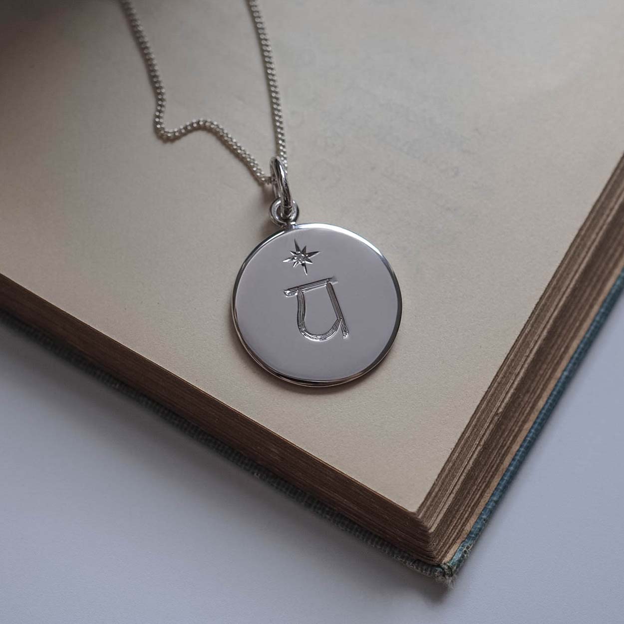 Chakra Necklace in the Chakra Necklace Collection, hand-engraved with one of the seven sacred Chakra symbols and star-set with a brilliant Diamond, symbolising balance, spiritual harmony, and strength.