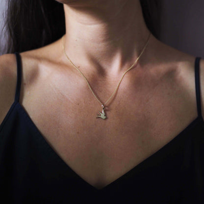 Solid gold swallow necklace symbolising love, loyalty, and freedom, available in yellow, rose, or white gold.