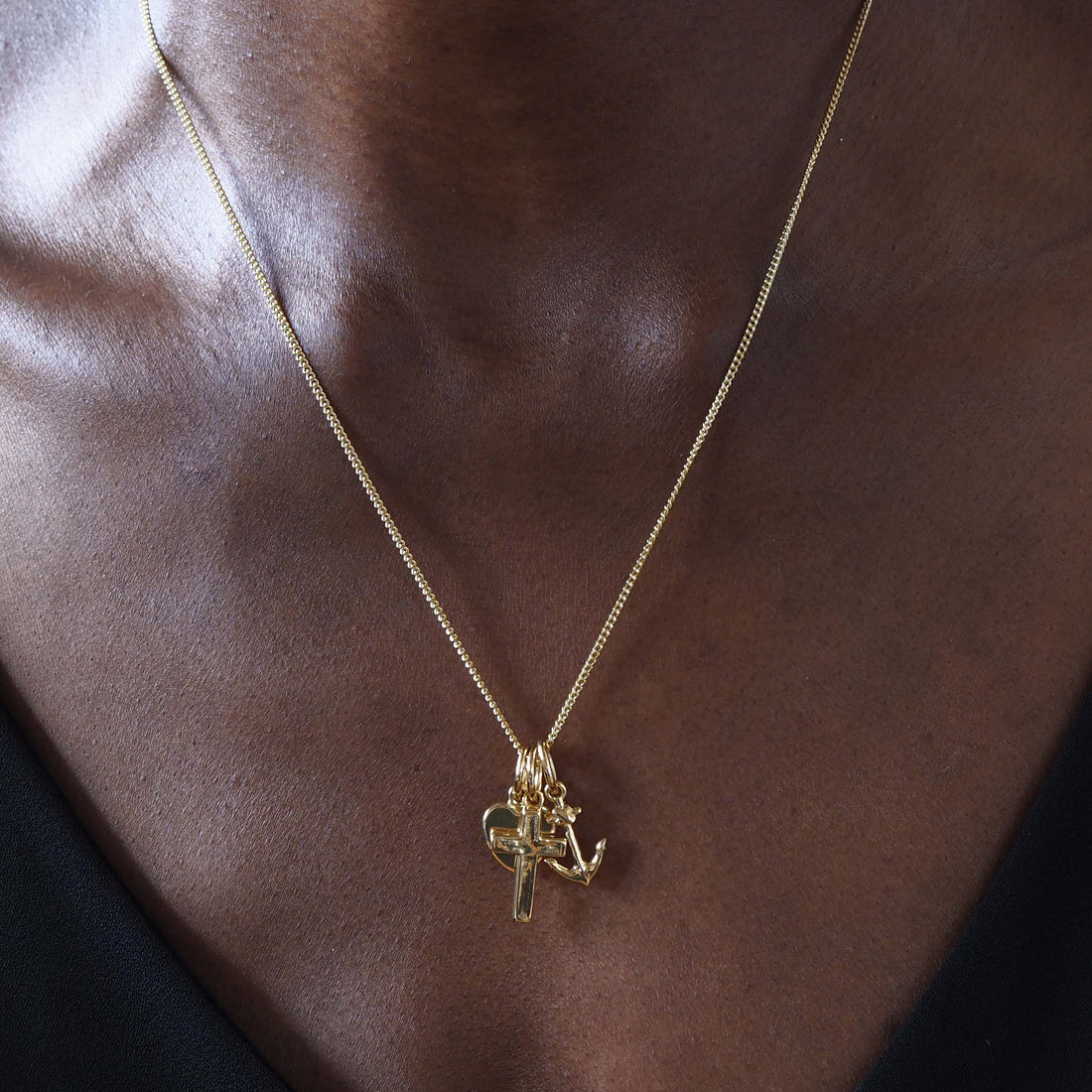 Faith, Hope, and Charity Necklace in solid 18ct gold, featuring a heart, anchor, and cross charm. Available in yellow, white, or rose gold, symbolising love, hope, and protection.