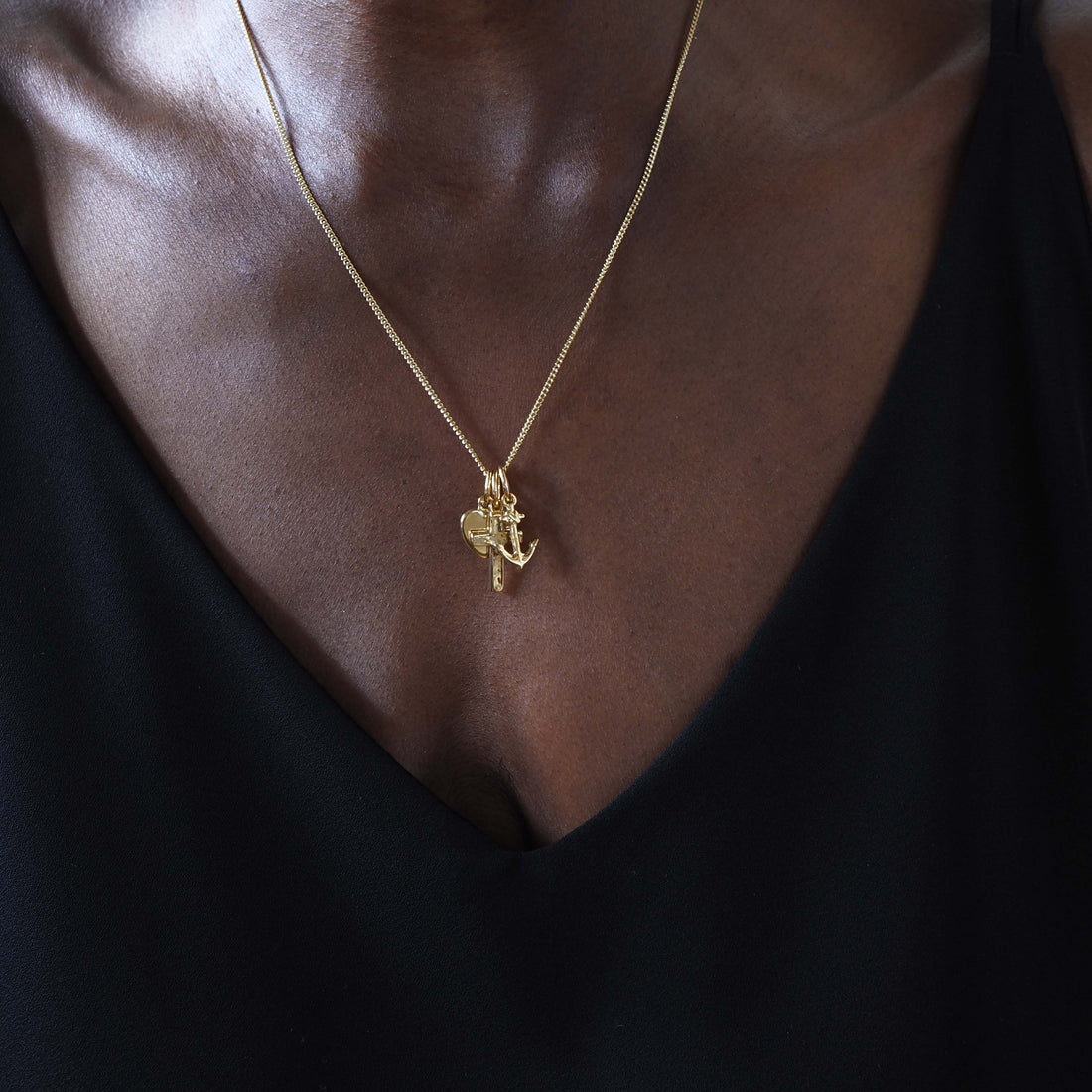 Faith, Hope, and Charity Necklace in solid 18ct gold, featuring a heart, anchor, and cross charm. Available in yellow, white, or rose gold, symbolising love, hope, and protection.