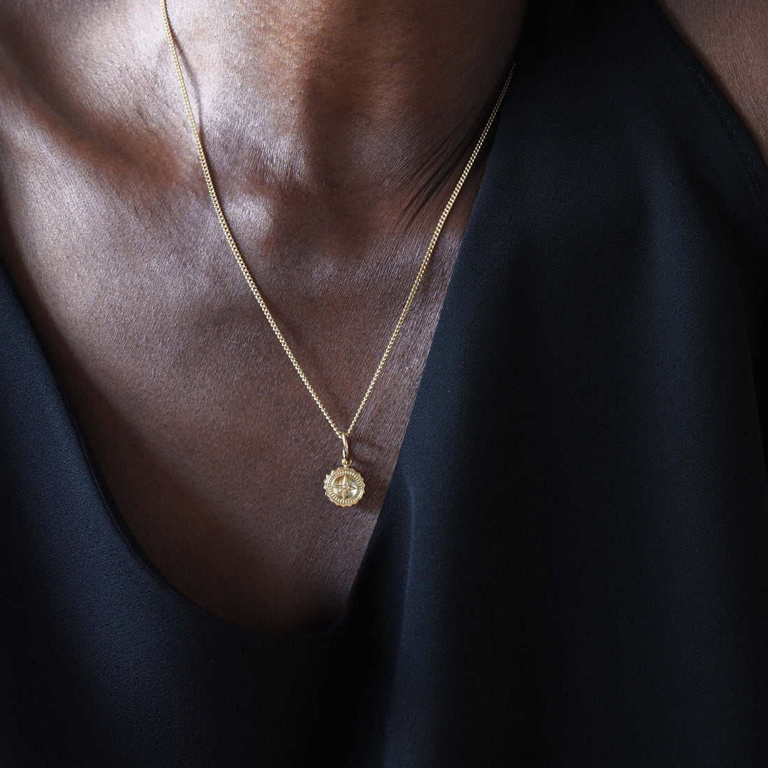 Solid 18ct gold Compass Mini Necklace, featuring a delicate charm that symbolises guidance and strength. Handcrafted in London, perfect for travellers and those embarking on new journeys.