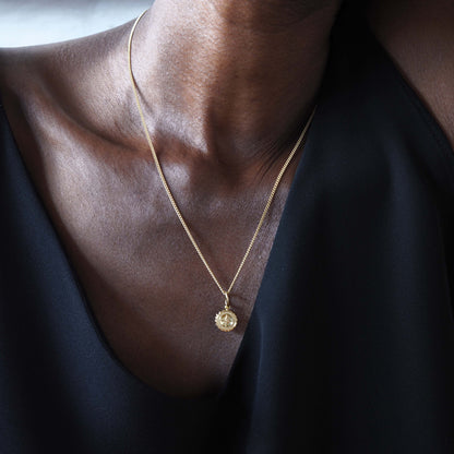 Solid 18ct gold Compass Mini Necklace, featuring a delicate charm that symbolises guidance and strength. Handcrafted in London, perfect for travellers and those embarking on new journeys.