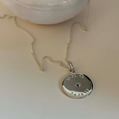 Weighty 1.3mm recycled sterling silver necklace with two engraved dates and star-set birthstones, celebrating meaningful milestones and crafted sustainably.