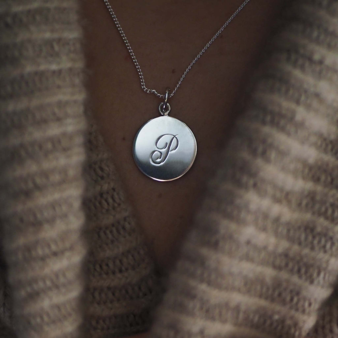 Sterling Silver Initial Necklace with a hand-engraved scrolled initial, inspired by Victorian love tokens. A timeless and personalised keepsake symbolising love and cherished connections.