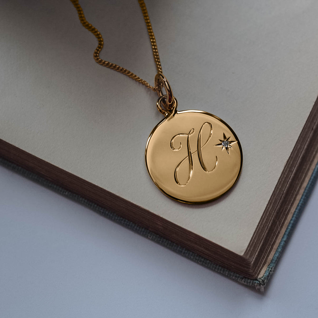 August Birthstone Peridot Initial Necklace with a hand-engraved scrolled initial and brilliant-cut Peridot, set in a Victoriana-inspired design, symbolising joy, compassion, and strength.