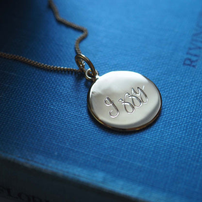 Personalised Name Necklace in Solid Sterling Silver or Gold Vermeil, featuring hand-engraved scrolled text. A timeless symbol of love and connection.