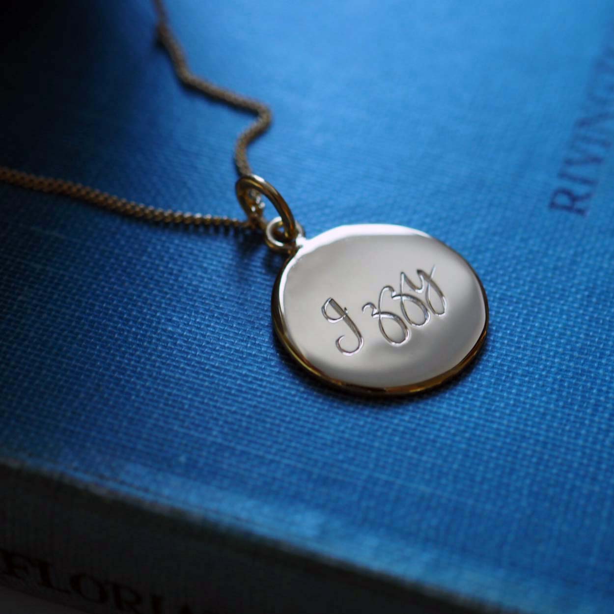 Personalised Name Necklace in Solid Sterling Silver or Gold Vermeil, featuring hand-engraved scrolled text. A timeless symbol of love and connection.