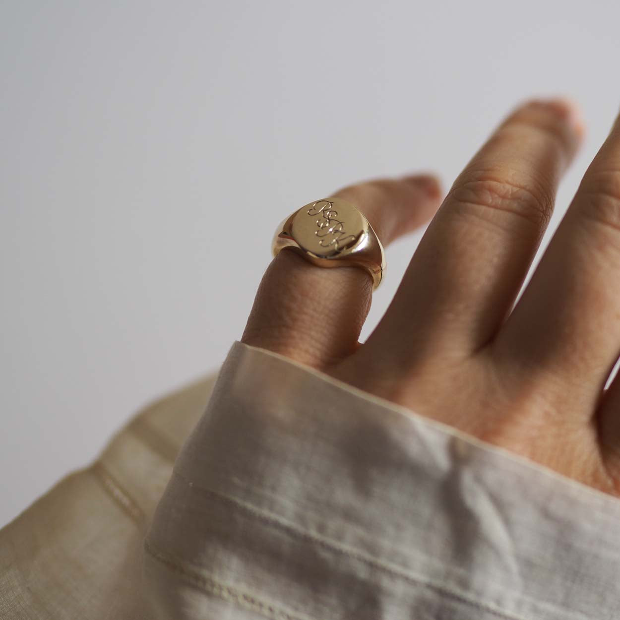  Handmade Triple Initial Signet Ring with intricate scrolled initials, symbolising timeless elegance and individuality