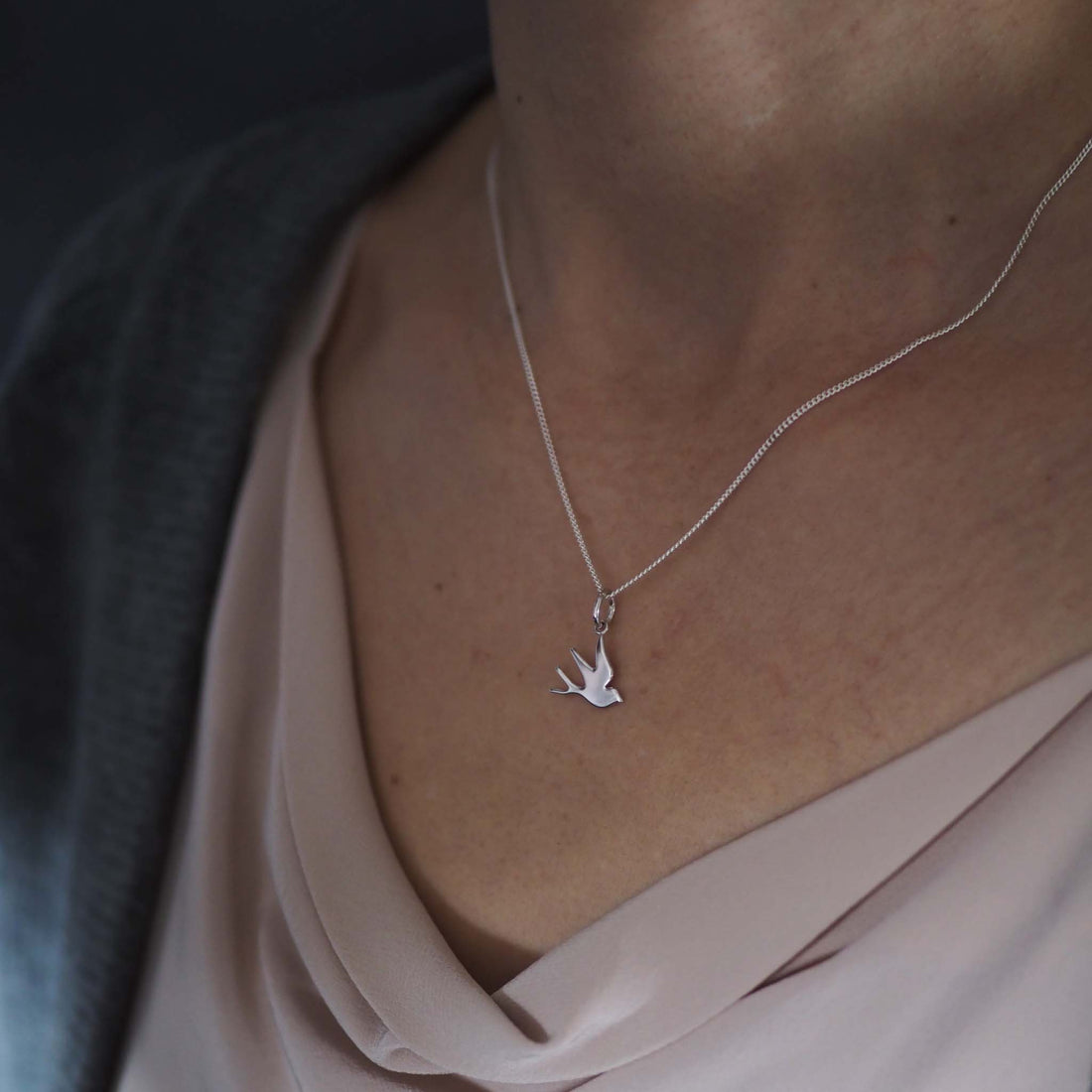 Bianca Jones flat, highly polished swallow charm in sterling silver or gold vermeil, symbolising freedom and hope